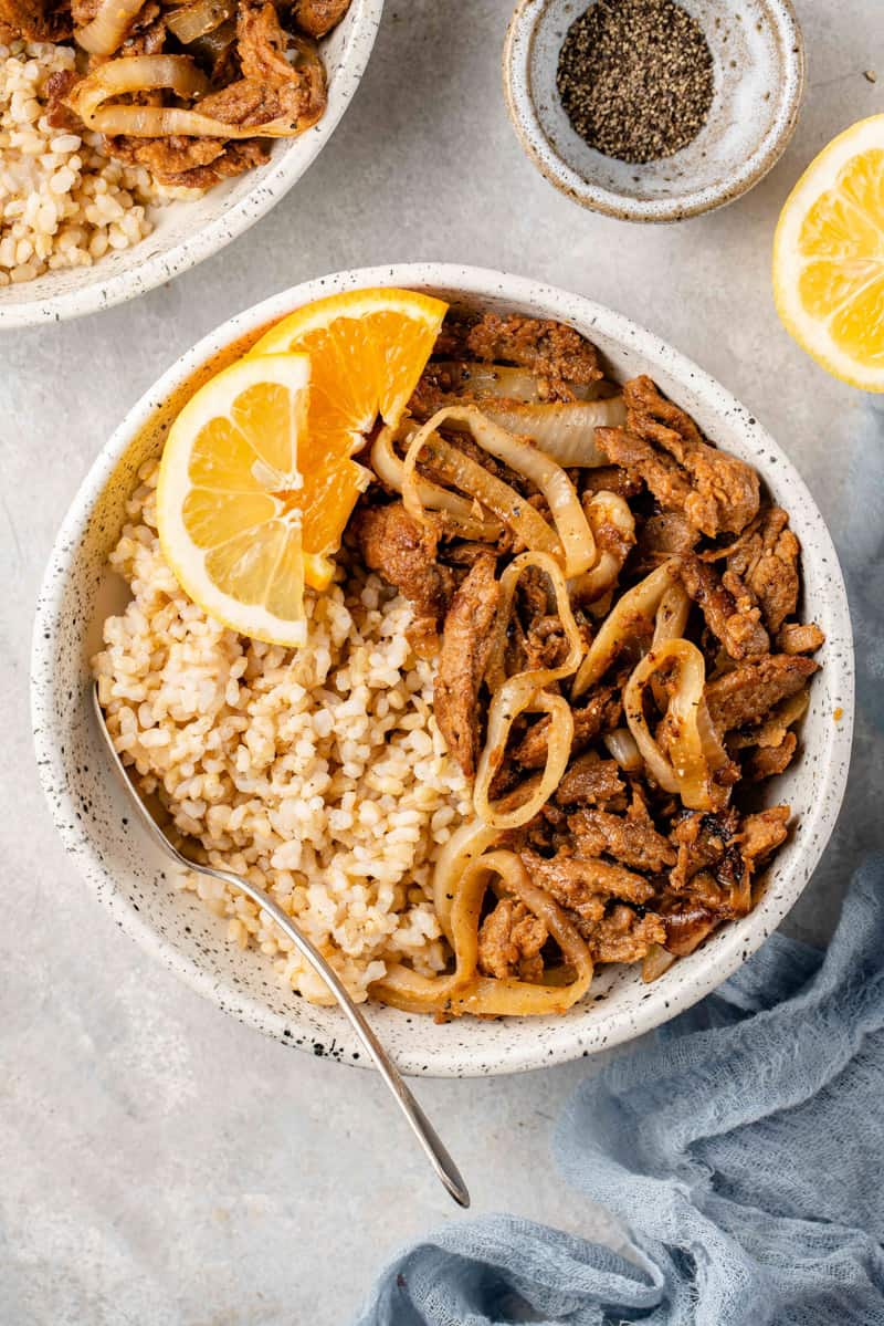 overhead image of bistek tagalong with citrus and a fork