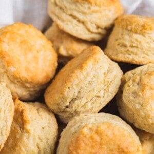 a basket of vegan buttermilk biscuits on parchment paper