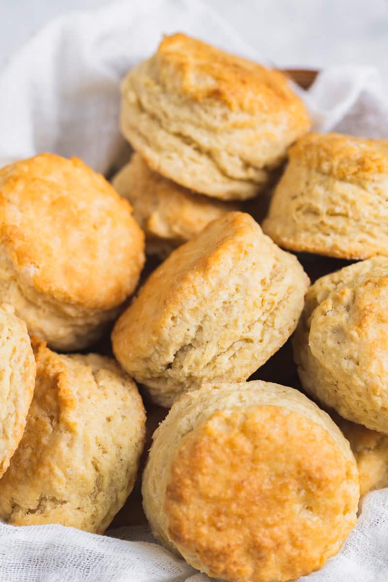 a basket of vegan buttermilk biscuits on parchment paper