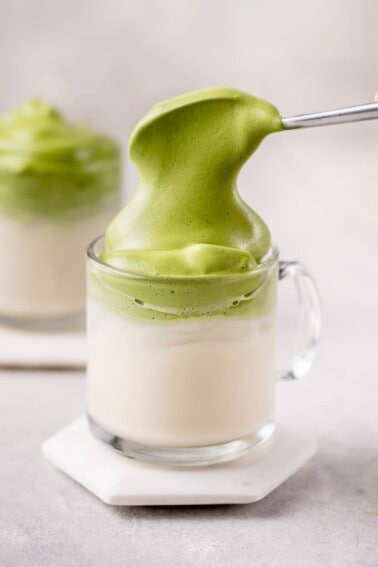 straight forward macro image of dalgona matcha latte with spoon