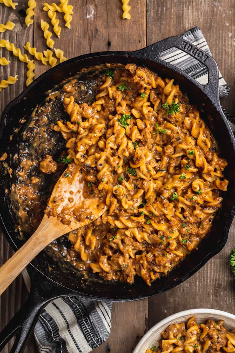 overhead image of skillet of one pot vegan hamburger helper with spoon