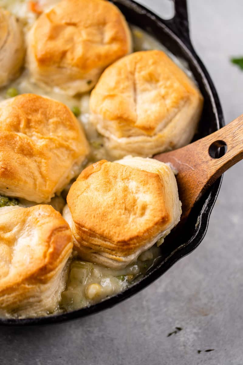 macro image of skillet biscuit pot pie being scooped