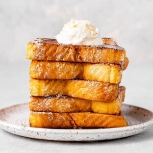 a stack of french toast with whipped cream