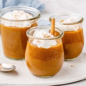 pumpkin pie pudding in a glass weck jar with coconut whipped cream