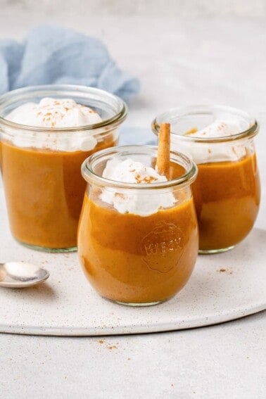 pumpkin pie pudding in a glass weck jar with coconut whipped cream