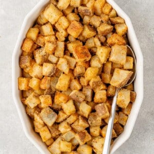 overhead image of crispy fiesta potatoes in baking dish with spoon