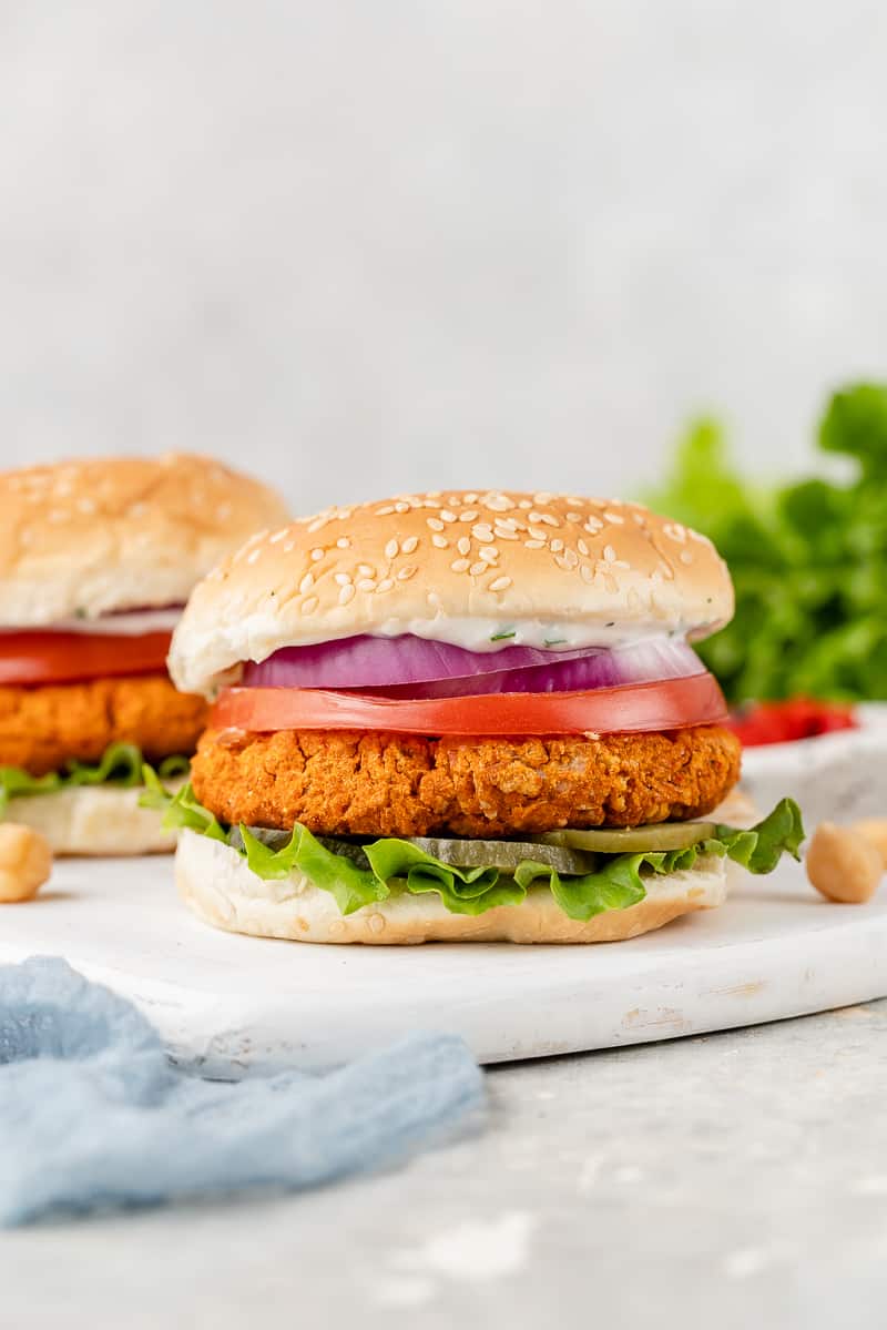 chickpea burgers on a white plate with a blue towel and lettuce