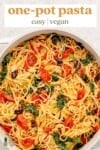 vegan pasta in a pot with tomatoes, kale, olives, basil and parmesan for pinterest