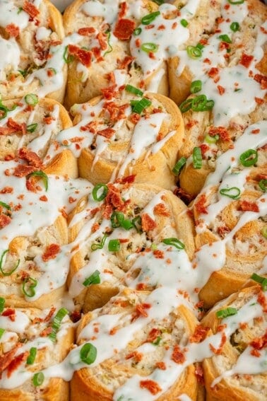 close up photo of jalapeño popper rolls in white baking dish