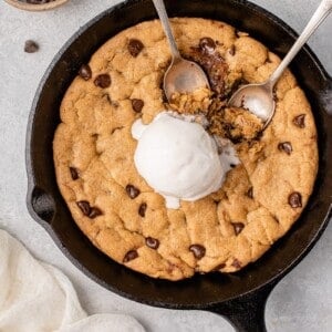 vegan chocolate chip skillet cookie with ice cream being eaten