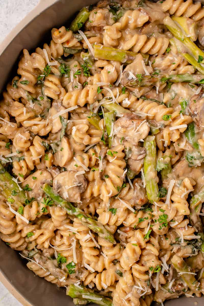 macro image of creamy one pot pasta topped with vegan parmesan