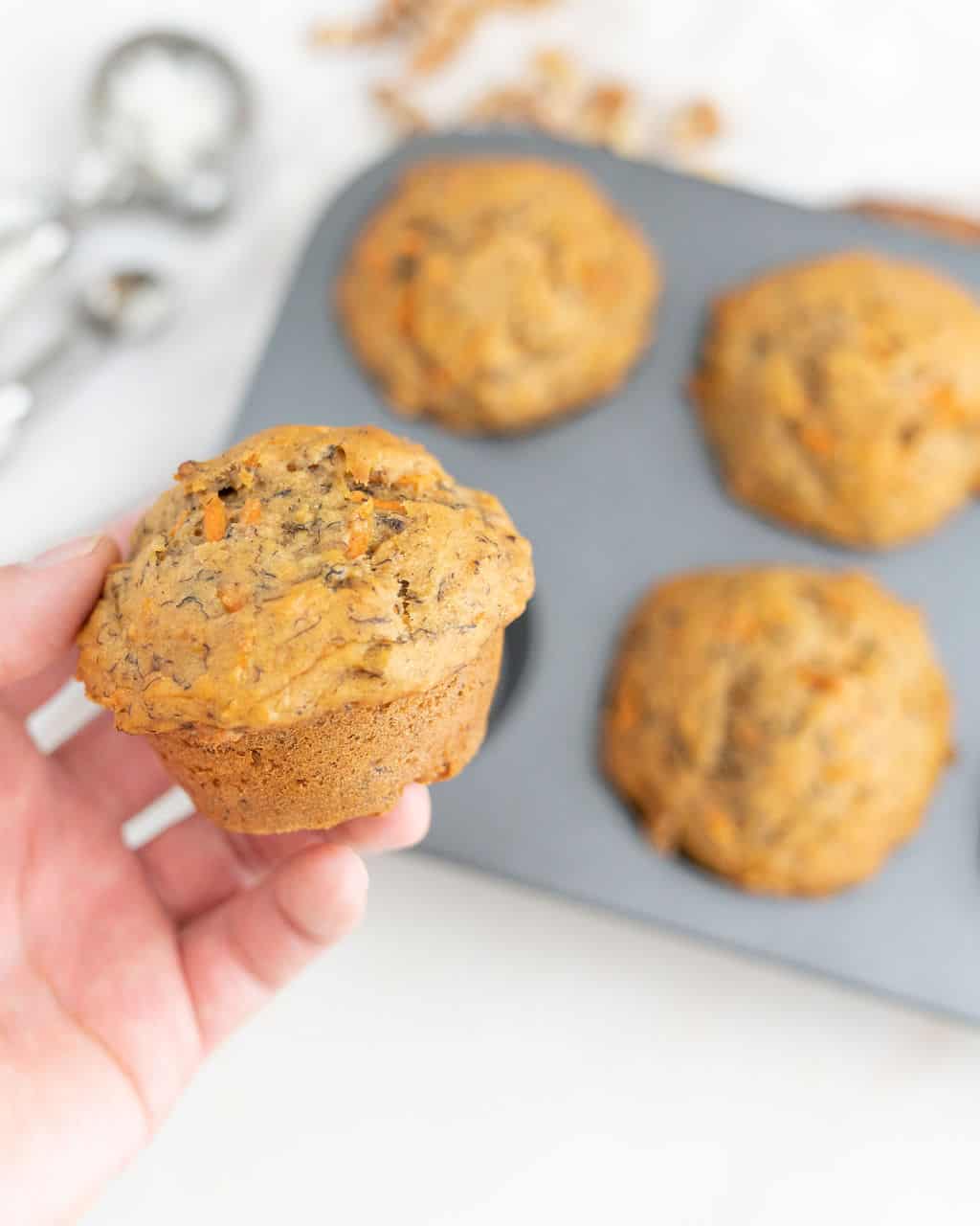 carrot cake muffins held in hand. 