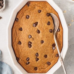 an overhead photo of chocolate chip baked oatmeal with a serving spoon