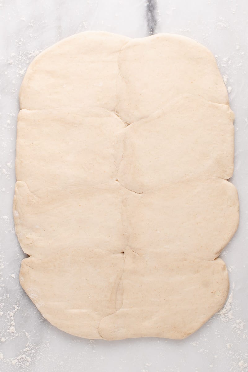 rolled out biscuit dough on marble slab