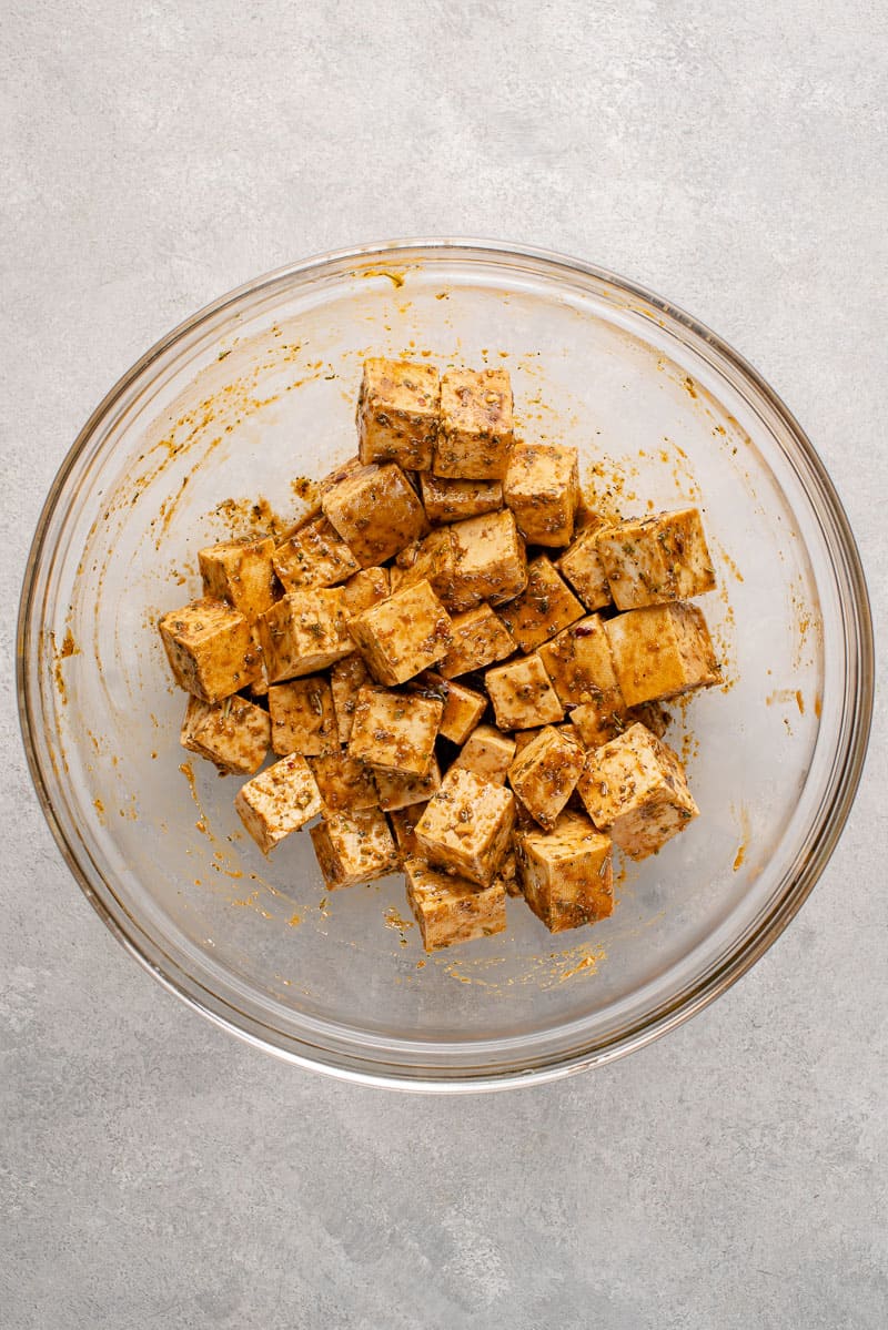 overhead image of uncooked tofu marinating in a bowl