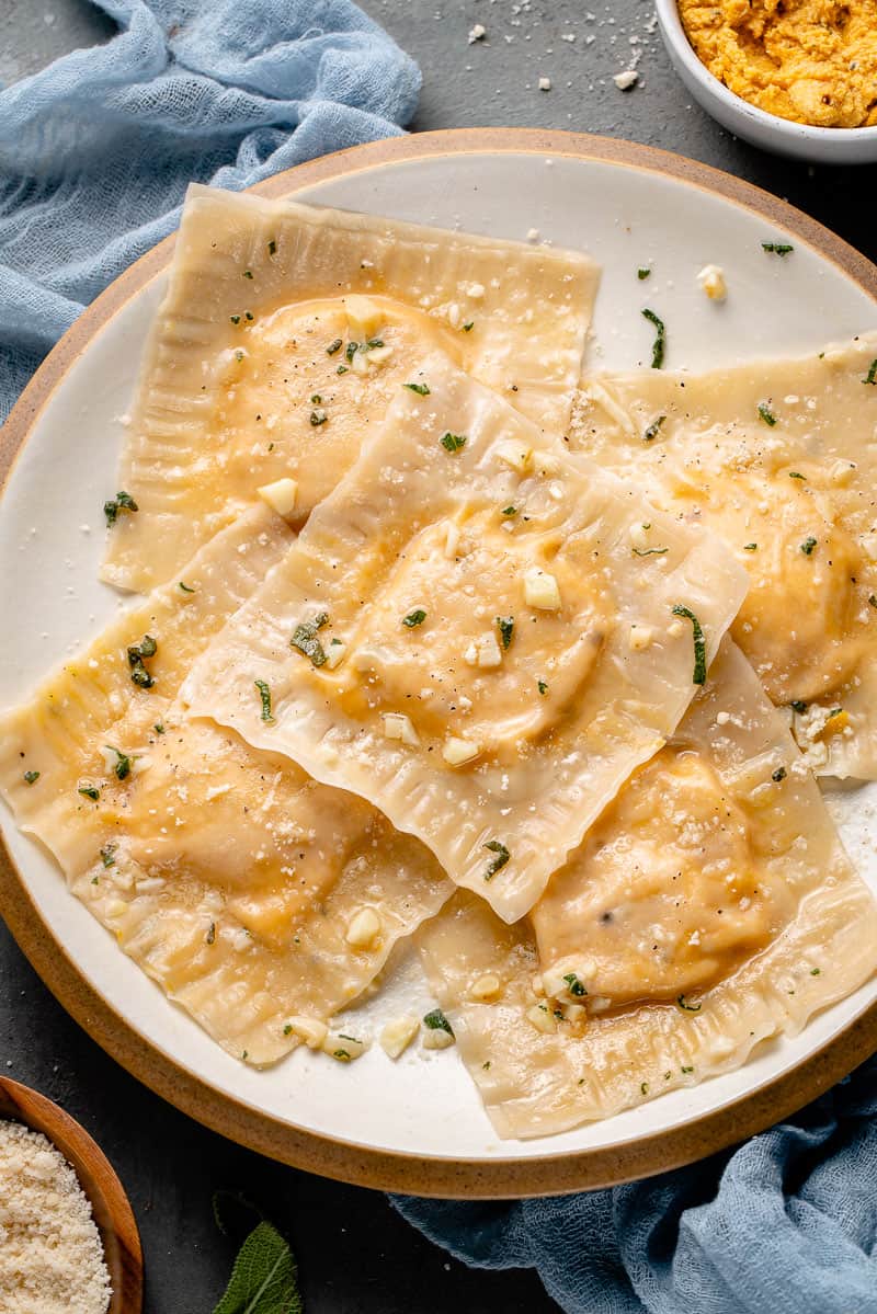 close up of butternut squash ravioli on a white plate