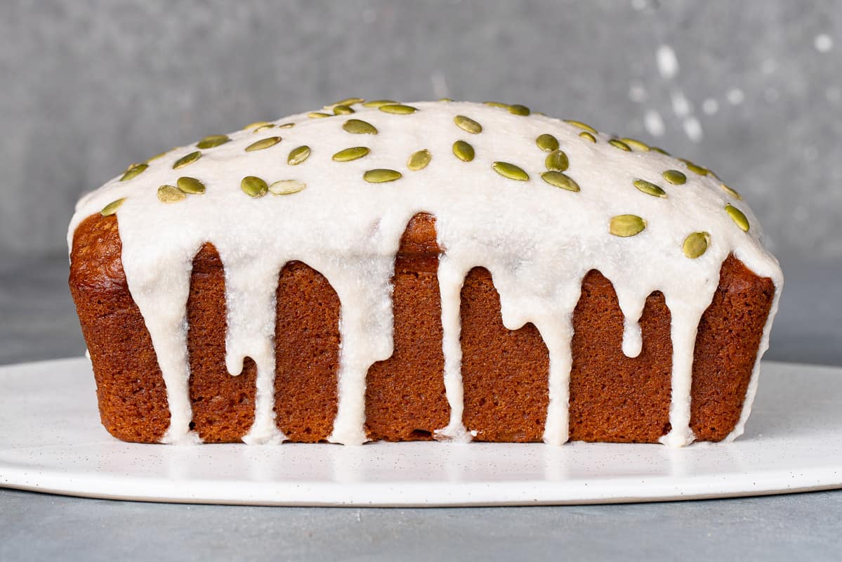 vegan pumpkin bread with cream cheese icing and pumpkin seeds