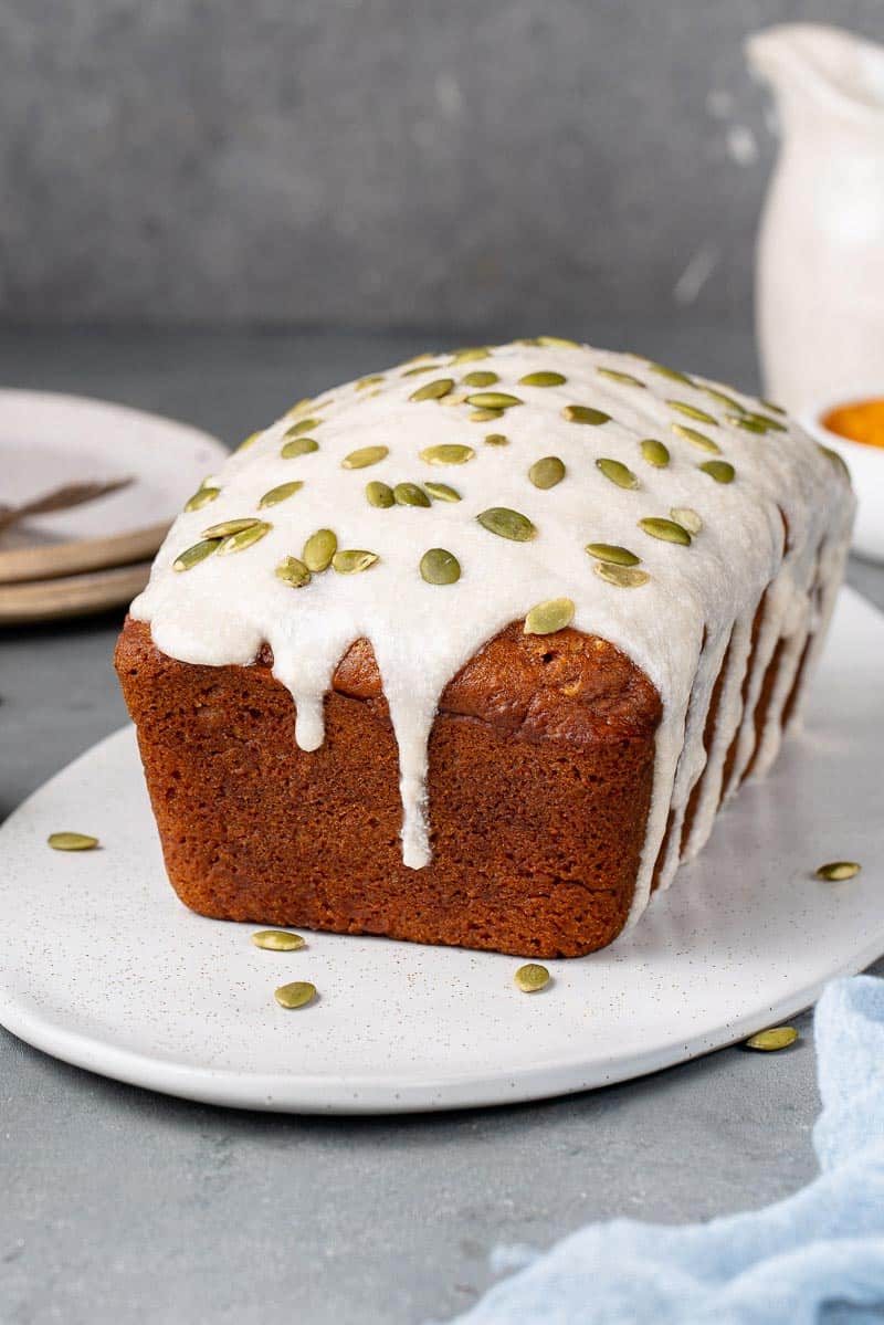 vegan pumpkin bread with cream cheese icing and pumpkin seeds