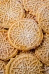 stacked pizzelles dusted with powdered sugar