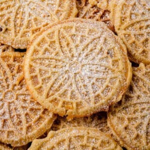 stacked pizzelles dusted with powdered sugar