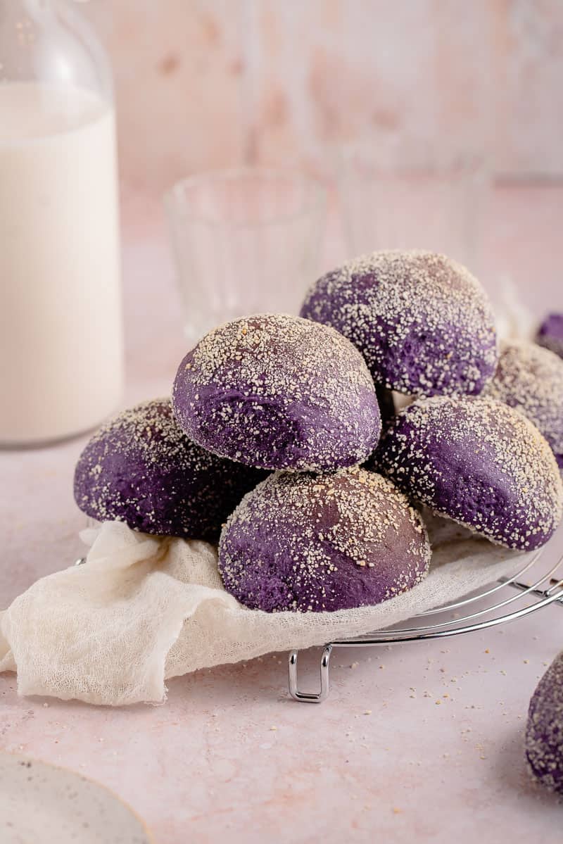 ube pandesal stacked on a plate