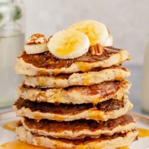 stack of vegan banana pancakes with maple syrup drizzle