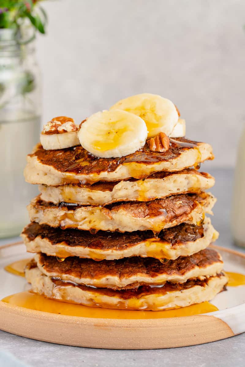 stack of vegan banana pancakes with maple syrup drizzle