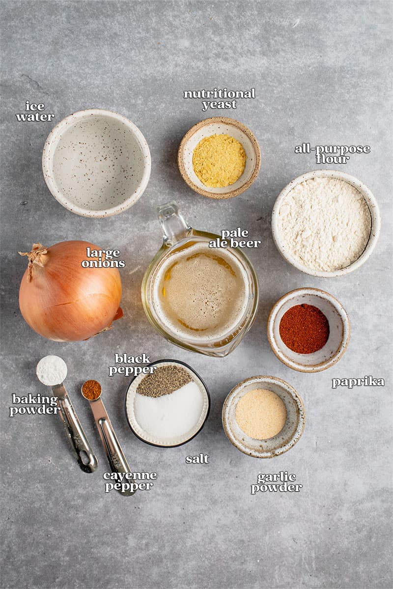 ingredients for beer battered onion rings on gray background