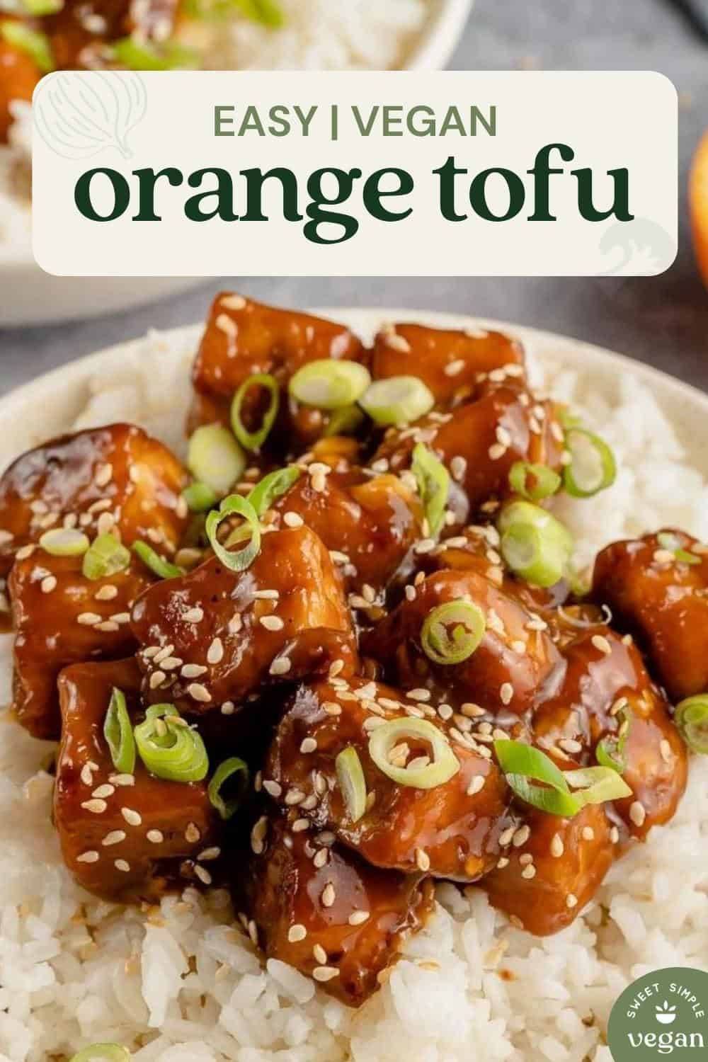close up of saucy vegan orange tofu in a bowl with rice for pinterest