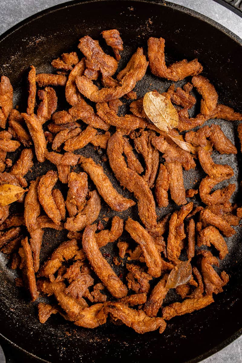 close up of Filipino Adobo Inspired Jerky in cast iron skillet