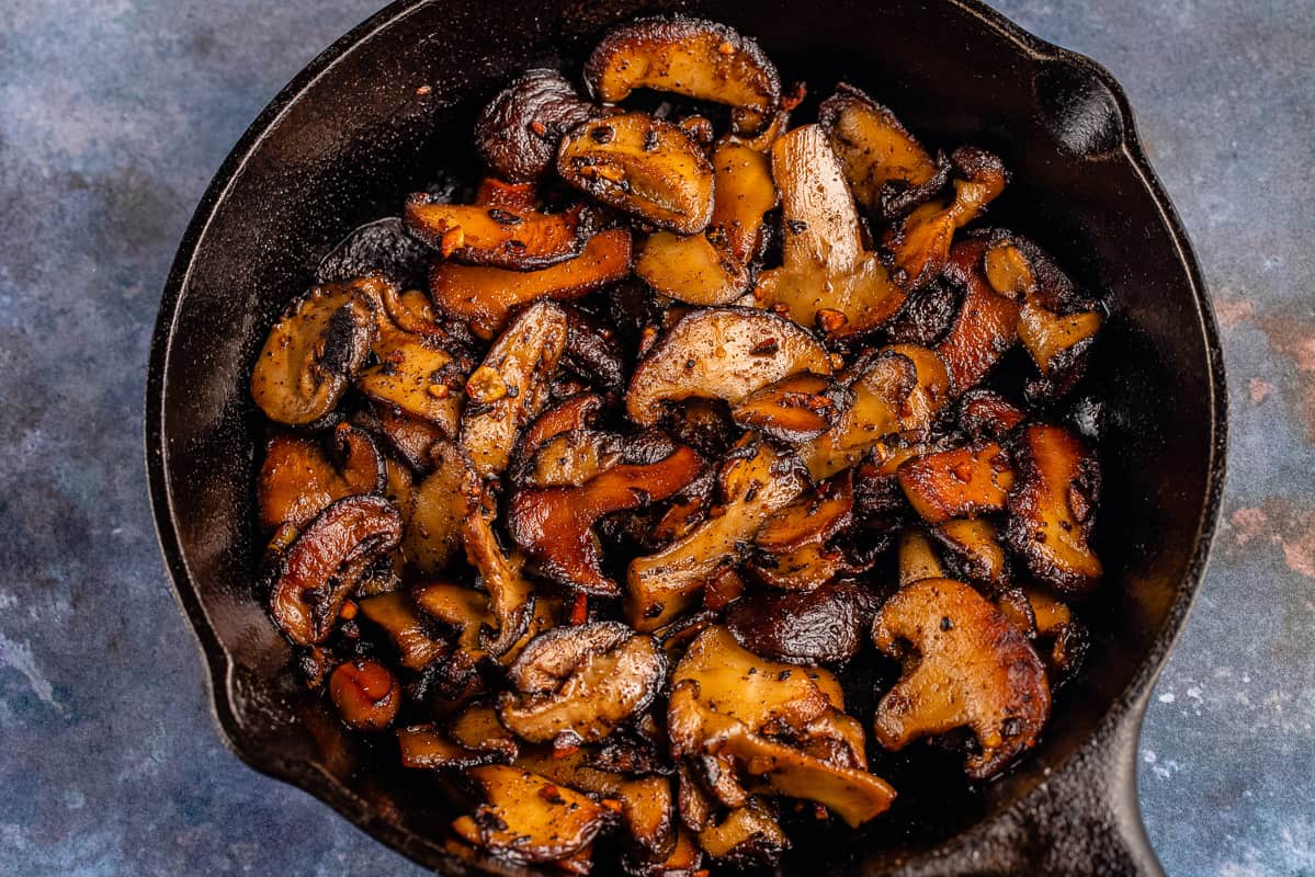 horizontal photo of Garlic Butter Miso Mushrooms in cast iron skillet