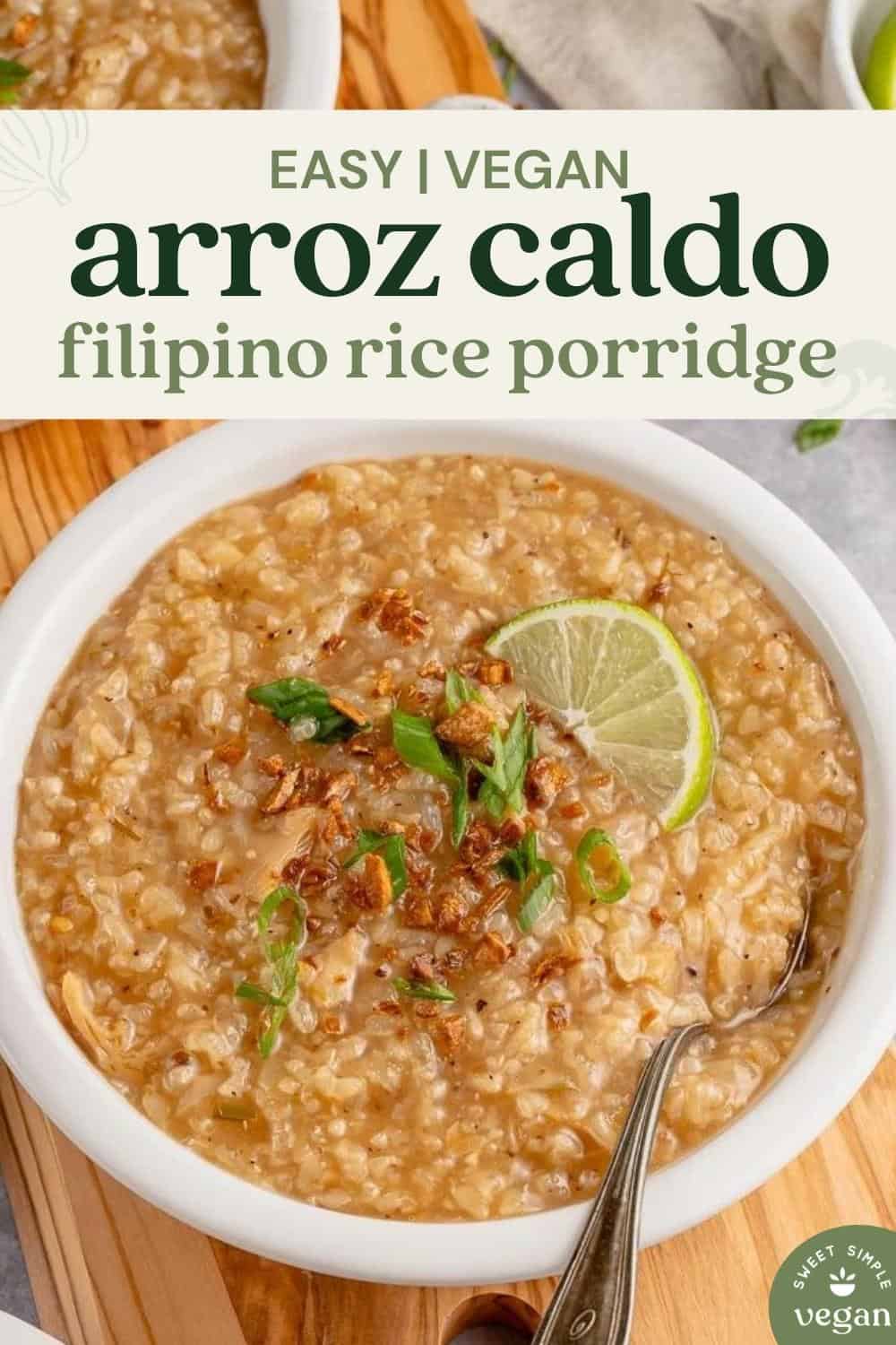 vegan arroz caldo in a white bowl with green onions, lime and crispy garlic for pinterest