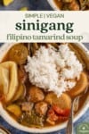 vertical photo of vegan sinigang and rice in a white bowl with a spoon for pinterest