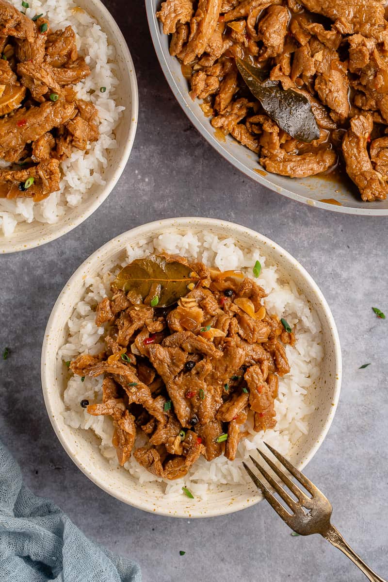 vegan coconut milk adobo with rice in white bowl