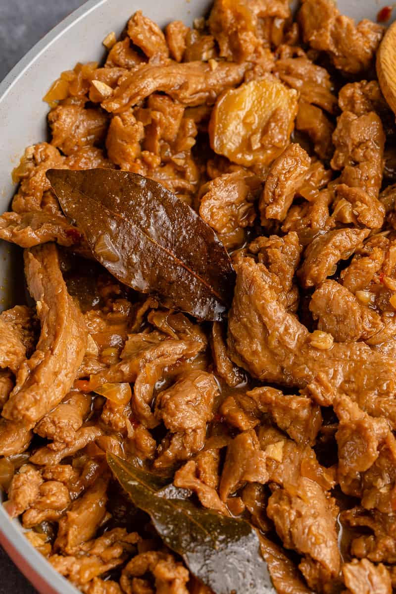 macro shot of vegan coconut milk adobo in gray pan