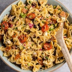 vertical photo of Italian-Inspired Pasta Salad in blue bowl