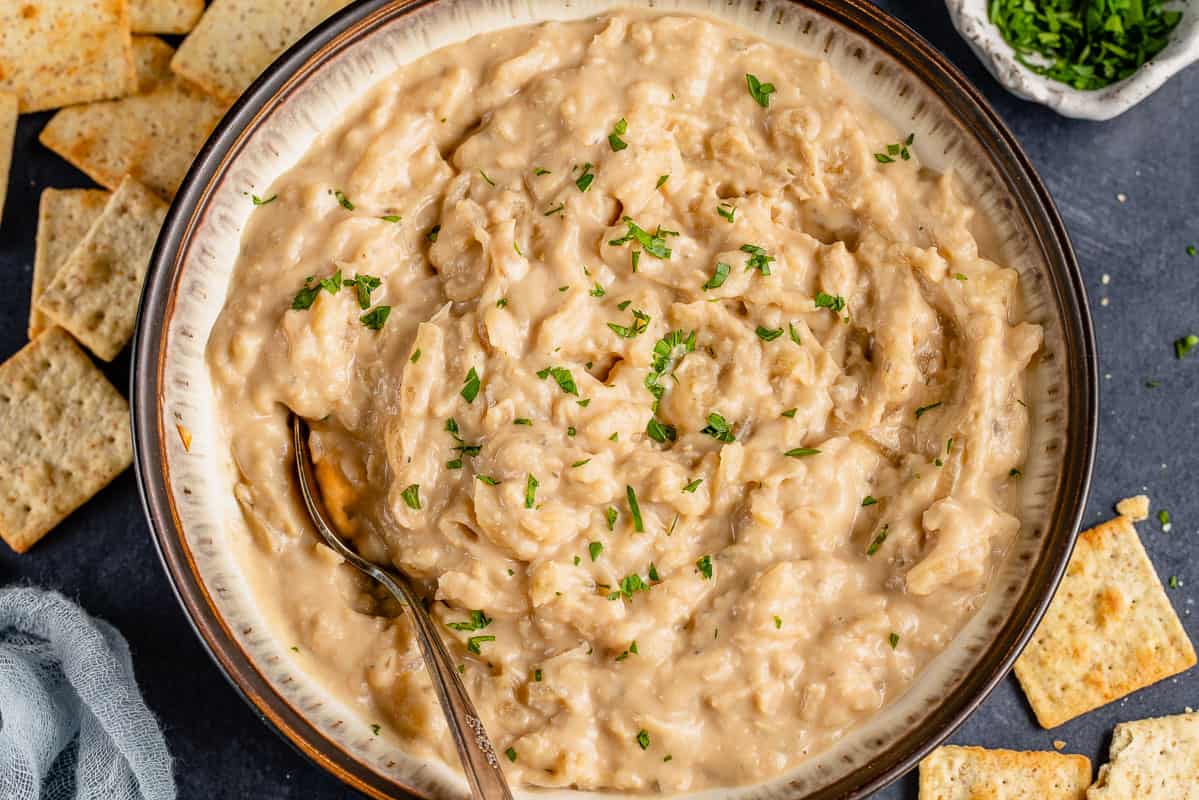 horizontal image of onion dip in bowl with crackers