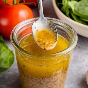 upclose image of salad dressing being picked up with spoon