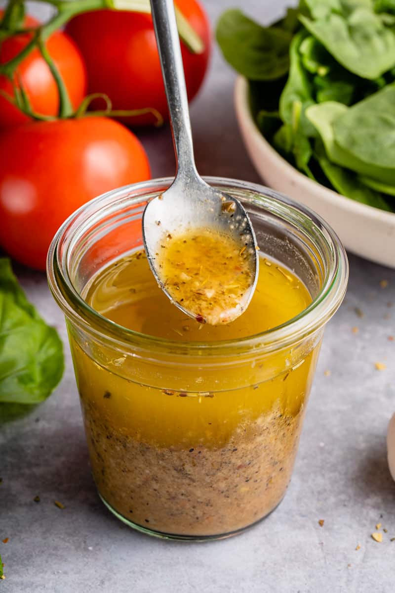 upclose image of salad dressing being picked up with spoon