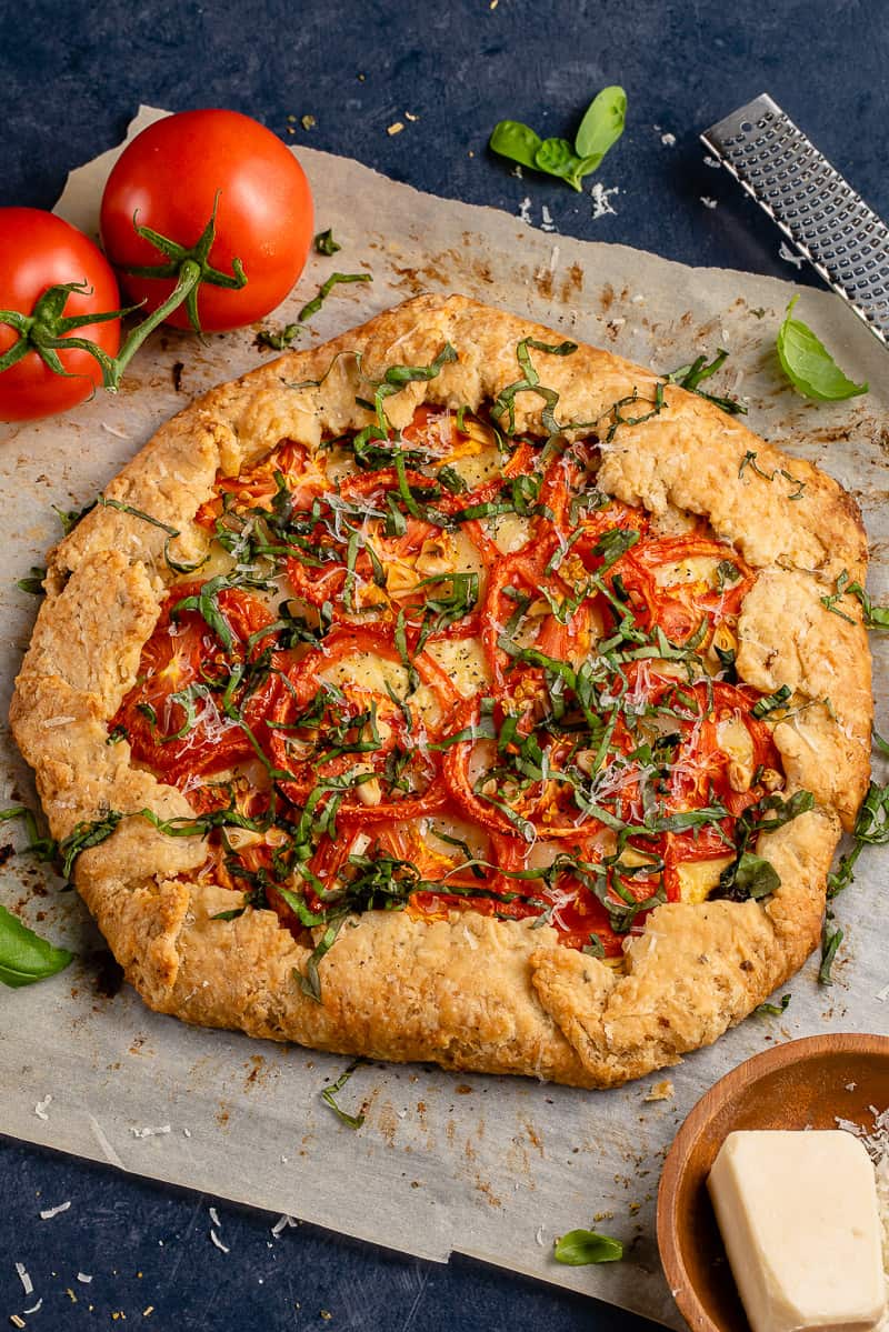 vertical photo of Vegan Tomato Galette on parchment paper