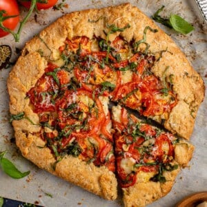 sliced Vegan Tomato Galette on parchment paper