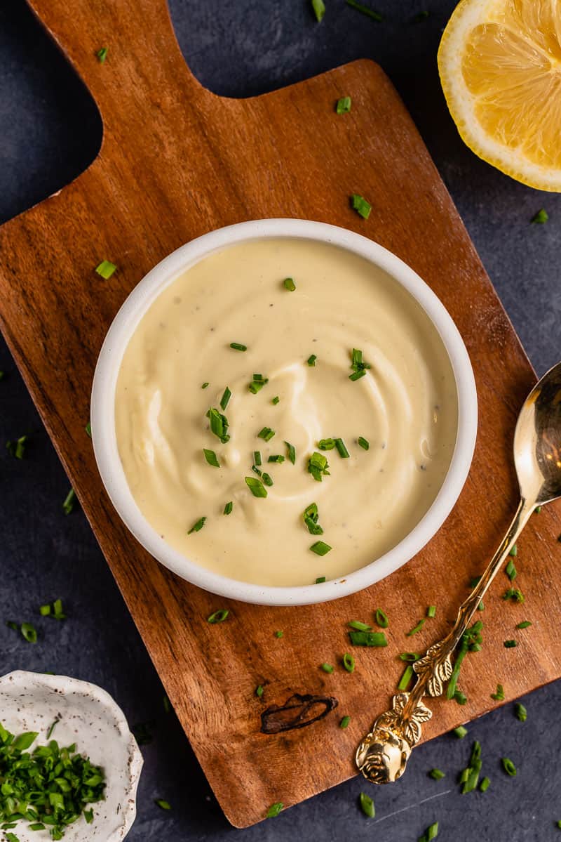 Garlic Truffle Aioli in white bowl with gold spoon and chives