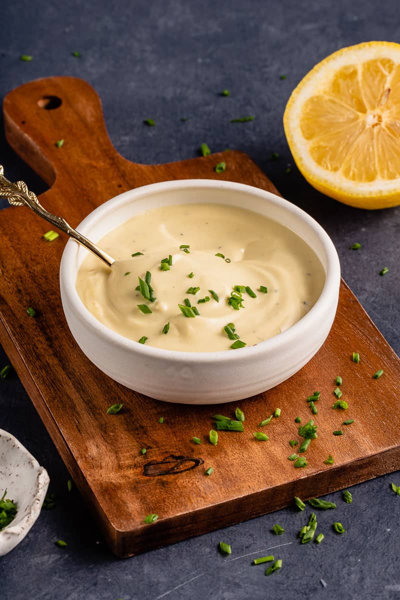 Garlic Truffle Aioli in white bowl with gold spoon and chives