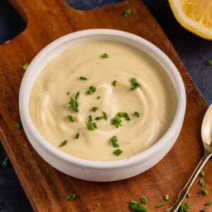 Garlic Truffle Aioli in white bowl with gold spoon and chives