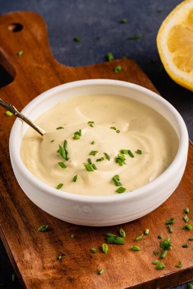 Garlic Truffle Aioli in white bowl with gold spoon and chives