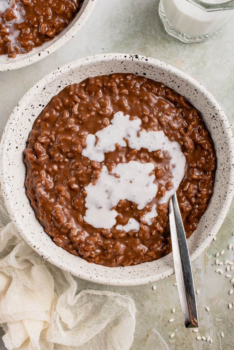 verticle image of champorado with spoon