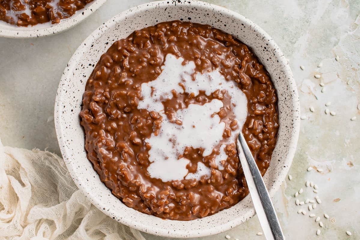 up close horizontal image of tsampurado with spoon