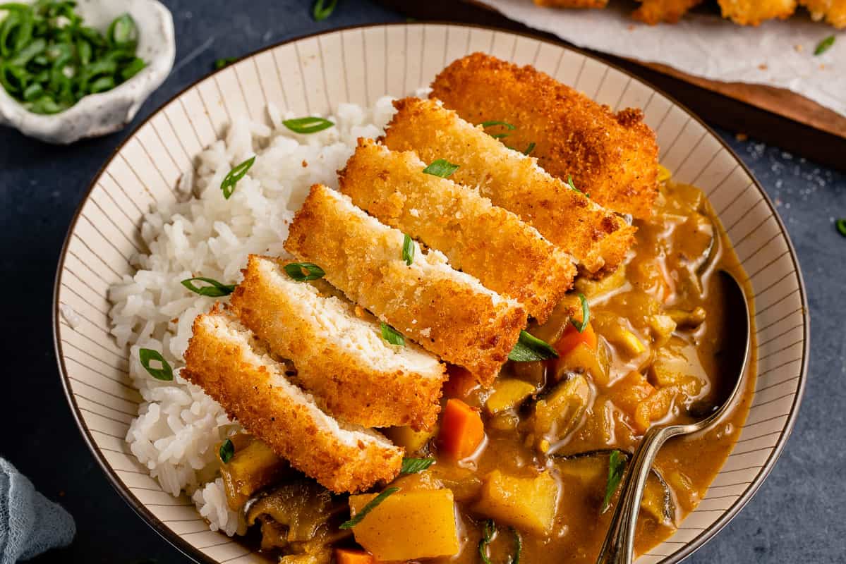 horizontal image of Japanese curry topped with tofu katsu