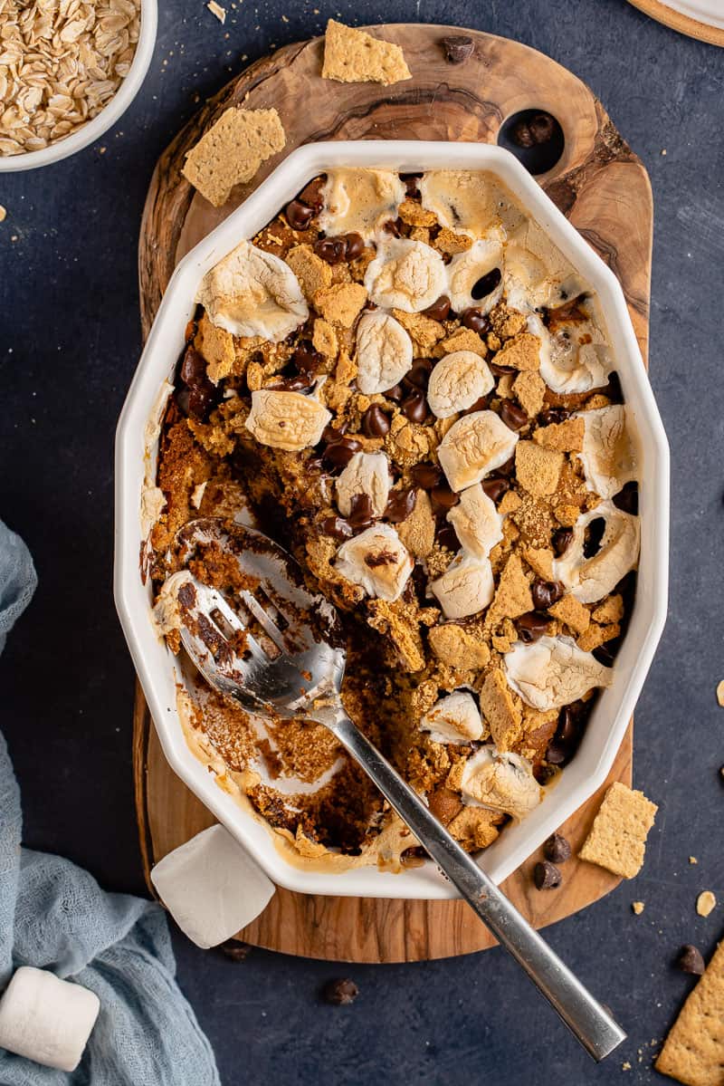 overhead image of s'mores baked oatmeal in a dish with spoon