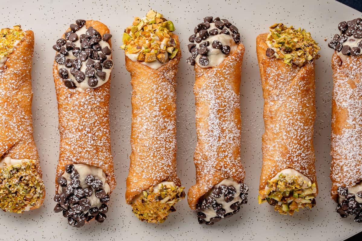horizontal photo of Vegan Cannoli with Chocolate and Pistachios on white plate